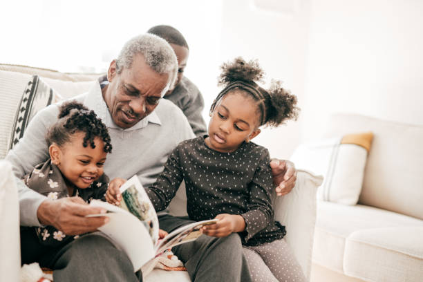 istock Grandad reading book for grandkids 1281355434