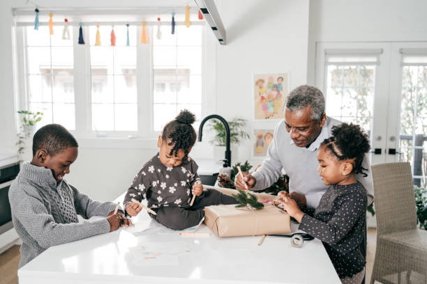 istock Grandfather helping kids to decorate the present 1281355452