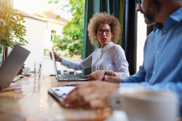 istock Diverse group of business people having a debate at the restaurant 1281355663