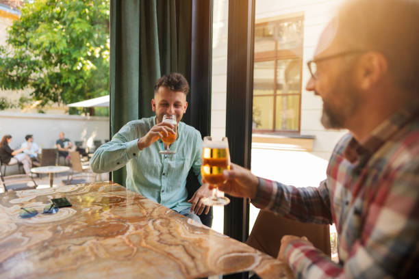 istock Two Caucasian friends enjoying drinking beer at the restaurant 1281355763