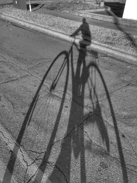 istock Shadow of a Man Riding a Bicycle 1281355767