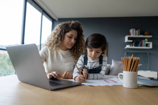 istock Mother supervising her son while home schooling during the pandemic 1281357136
