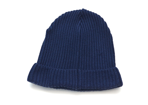 Closeup of a mass produced blue toque on a white background.