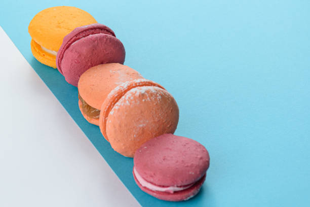 istock 5 macaroons lined up in a row on a blue background. 1281357824