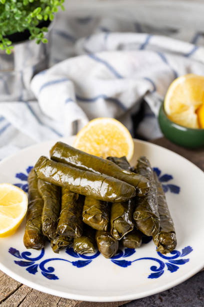 stuffed vine leaves with lemon/sarma/dolma from turkish and greek cuisine. - dolmades imagens e fotografias de stock