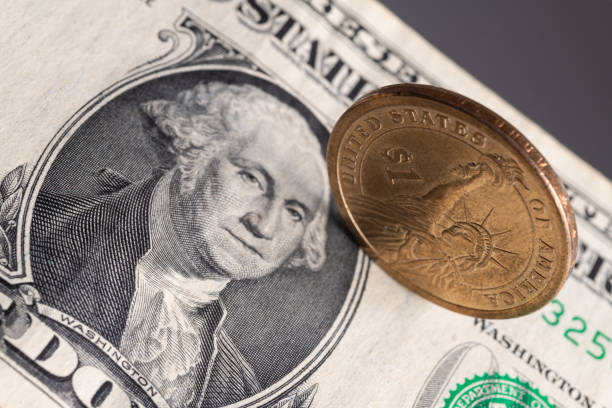 istock One American dollar coin and one dollar bill 1281361507