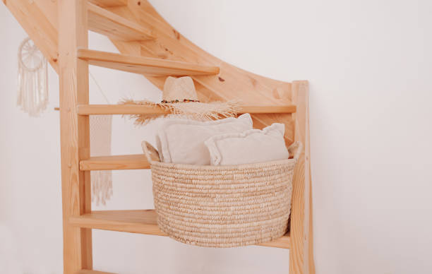 istock wicker storage basket with white pillow inside on wooden spiral staircase against white clean wall. stylish and convenient system storage at home 1281362697