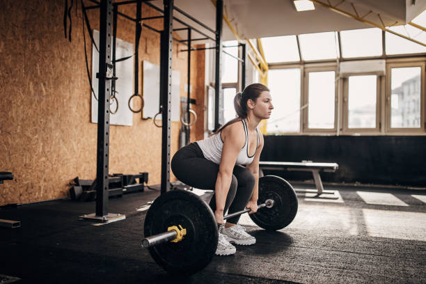 istock Strong woman training with weights in gym 1281363330