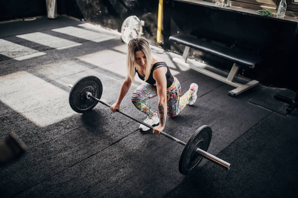 istock Fit woman training with weights in gym 1281363341