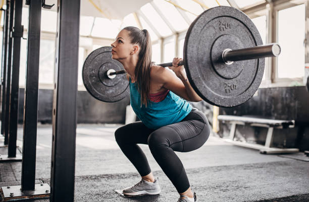 istock Fit woman training with weights in gym 1281363408