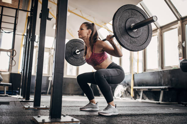 istock Fit woman training with weights in gym 1281363436