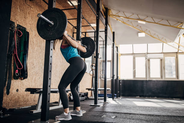 istock Fit woman training with weights in gym 1281363463