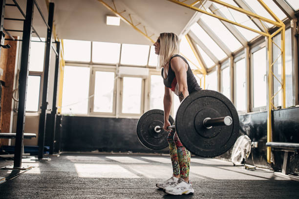 istock Fit woman training with weights in gym 1281363490
