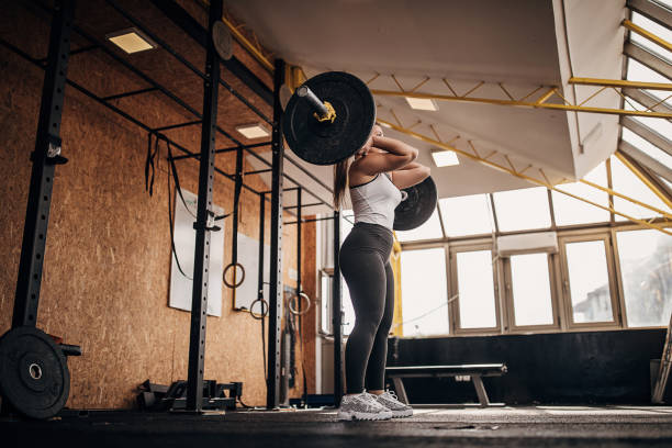 istock Strong woman training with weights in gym 1281363518