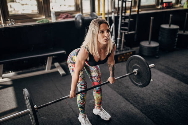 istock Fit woman training with weights in gym 1281363523