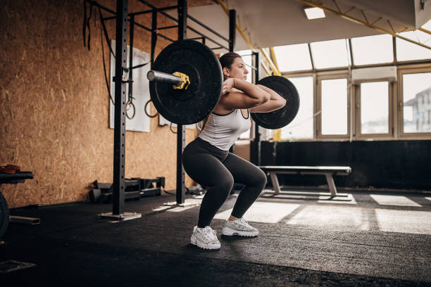 istock Strong woman training with weights in gym 1281363535