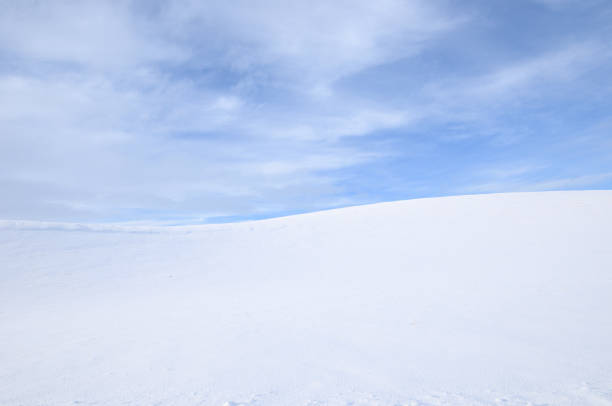 istock Snowy Countryside Under Partly Cloudy Sky 1281364236