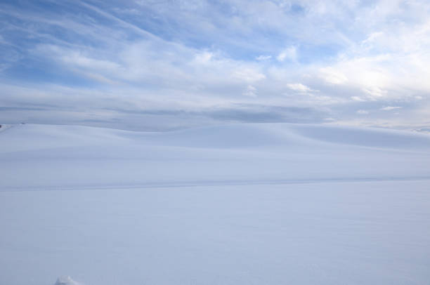 istock Snowy Countryside Under Partly Cloudy Sky 1281364269