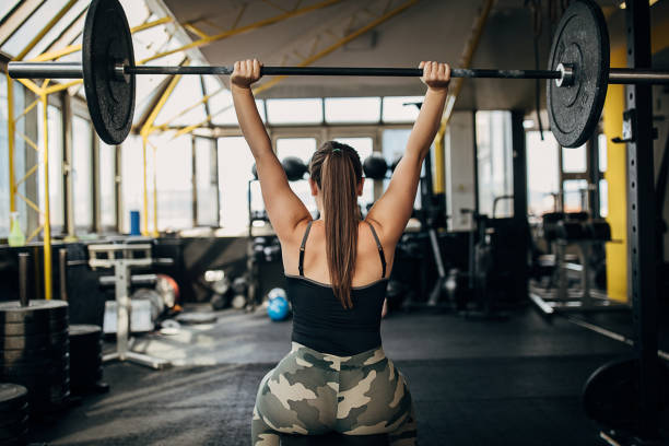 istock Strong woman training with weights in gym 1281365244