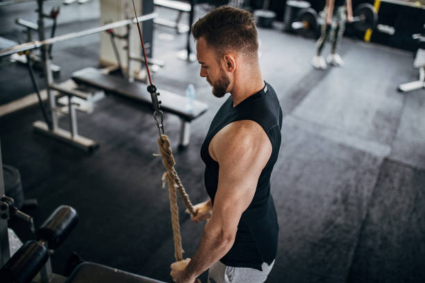 istock Fit man exercising with rope in gym 1281365910