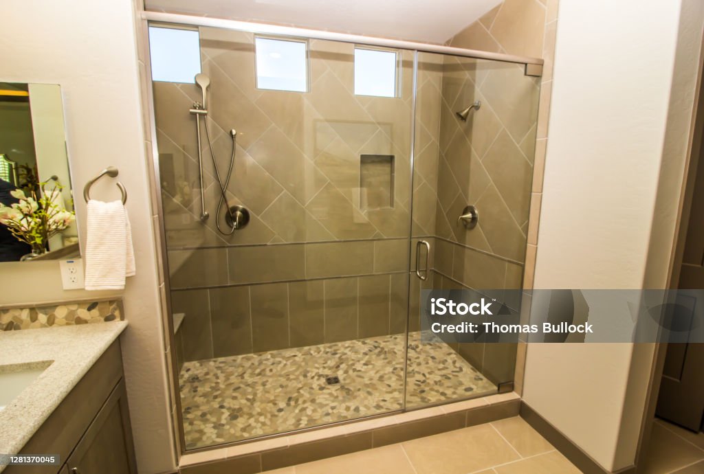 Bathroom Glass Shower With Door, Tile & Two Shower Heads Bathroom Shower With Glass Door, Tile, Windows & Two Shower Heads Shower Stock Photo