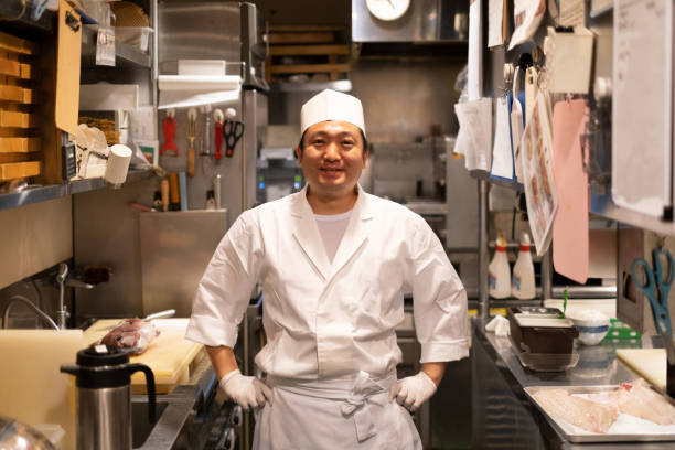 Portrait of Japanese chef in kitchen Portrait of Japanese chef in the kitchen of Japanese food restaurant japanese chef stock pictures, royalty-free photos & images