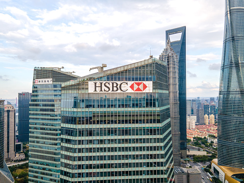 Shanghai, China - Sep 27, 2020: Hongkong and Shanghai Banking Corporation (HSBC) in downtown, brand logo and office building. Drone aerial view of cityscape finance business concept. Shanghai downtown