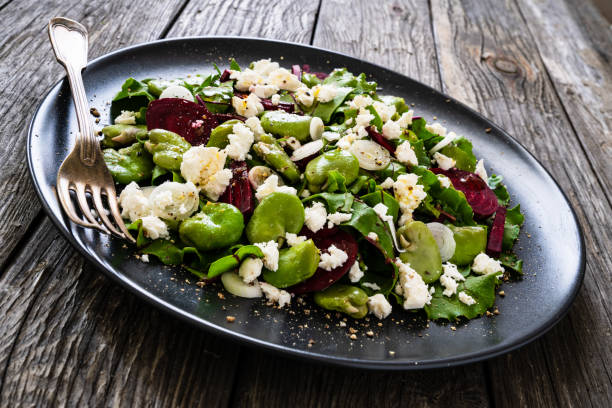 istock Beetroot salad with broad bean and goat cheese on wooden background 1281381704