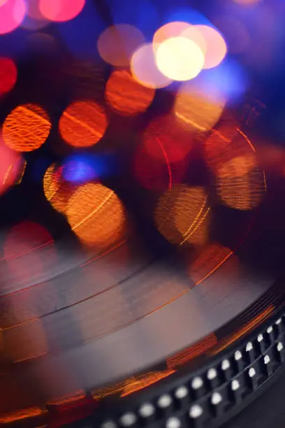 Vinyl player LP record with blured or defocused lights. Party concept