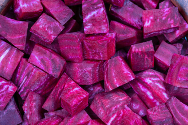 istock Fresh segments of a red beetroot, closeup. Purple beet slices background, top view 1281381924
