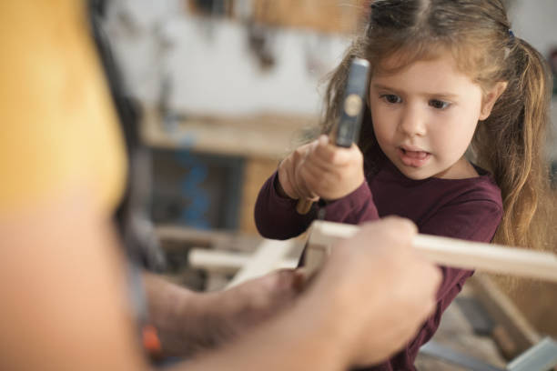 istock Father and daughter making wooden frame in workshop 1281384505