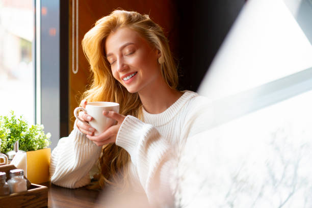 istock Woman at a cafe drinks tea. Close up portrait 1281384672