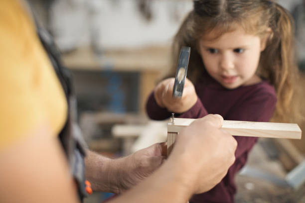 istock Father and daughter making wooden frame in workshop 1281384686