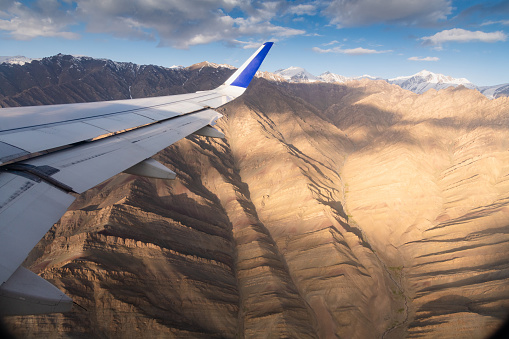 Plane window view  Beautiful scenics snowcapped mountain peak and cloyd in sunlight nature and mountain landscape background from Nubra valley in Leh, Ladakh India