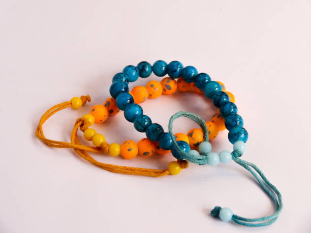 istock bracelet in orange and blue on white background 1281387018