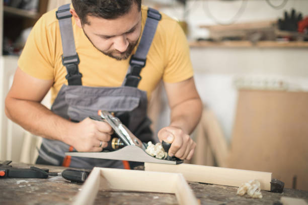 istock Father and daughter making wooden frame in workshop 1281387161