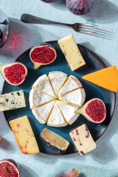istock Cheese selection, overhead vertical shot on a plate with fresh figs 1281388731