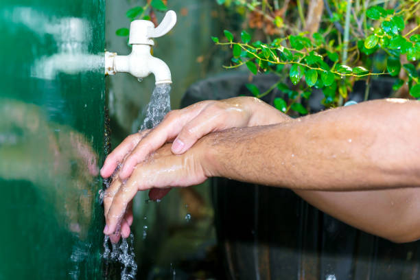 istock Man washing his hands with soap and running water 1281391462