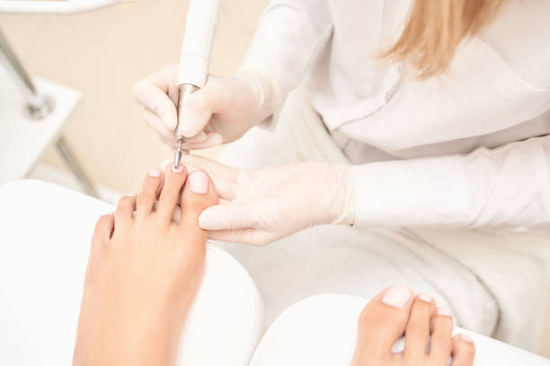istock Classic pink wedding toe nail manicure on white backdrop. Spa treatment concept 1281391630