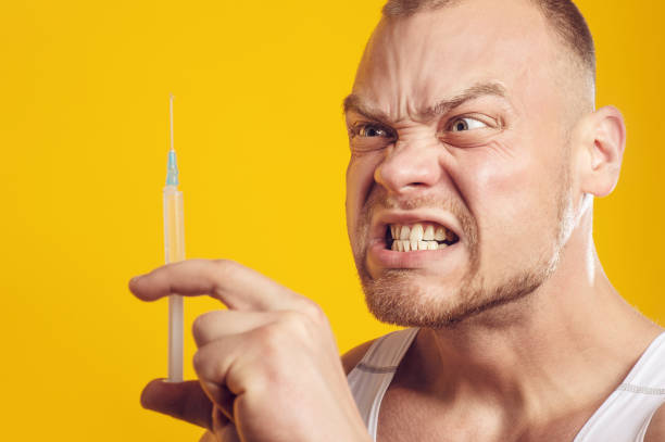 istock Studio portrait of man with pill and syringe 1281392440