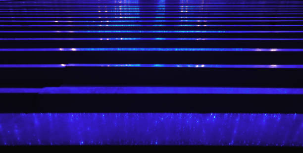 istock Abstract glowing dark blue background. Horizontal stripes-reflection of neon light on wet asphalt. 1281393466