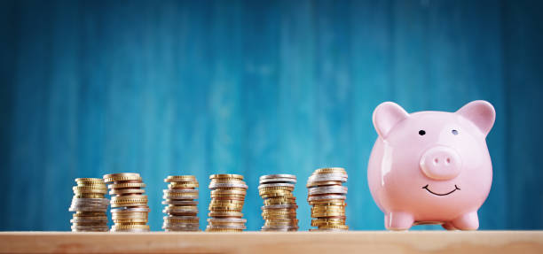 piggy bank with stacked coins on blue background