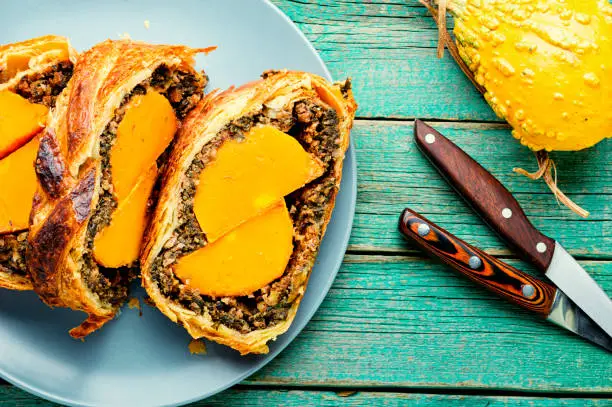 Loaf with baked pumpkin and mushrooms.Wellington pumpkin, autumn traditional food.