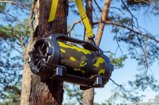 istock Outdoor Portable Wireless Bluetooth Speaker With Subwoofer Big hanging on tree in the forest. 1281394458