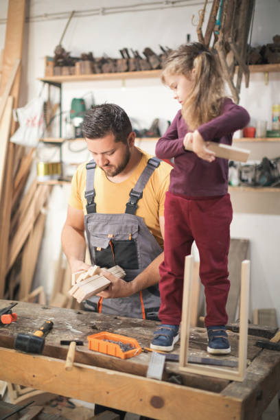 istock Father and daughter making wooden frame in workshop 1281395692