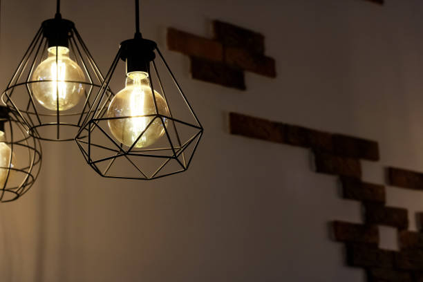 istock Retro style lamps on brick wall background 1281395757