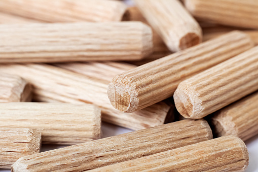 Wooden dowels in a heap close up, macro photo