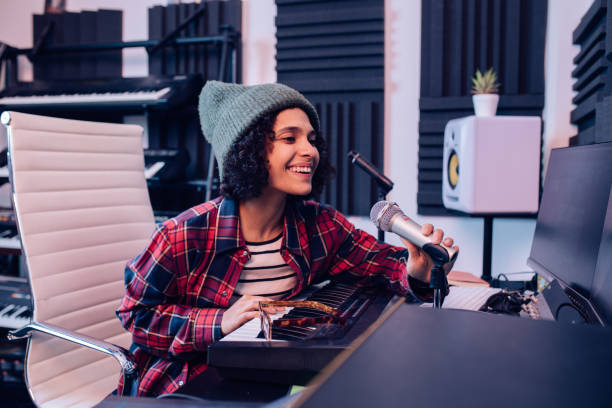 istock Young musician singing and playing keyboard at the music studio 1281397789