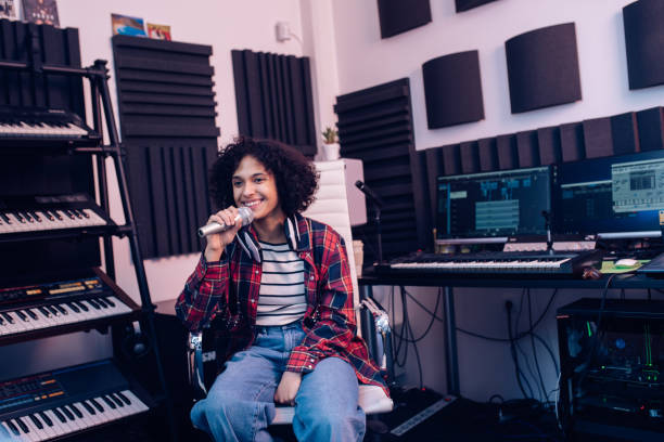 istock Young singer recording a song in the music studio 1281397798