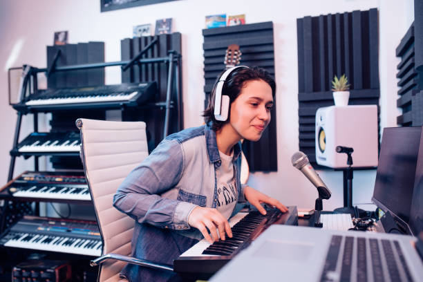istock Female musician recording a song at her studio 1281397810